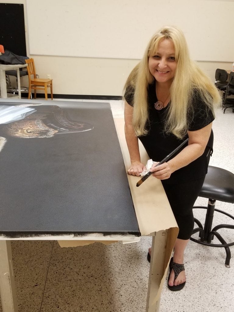 Kevin Grass's wife Michaela Oberlaender paints the edges of the "Not #MeToo" painting