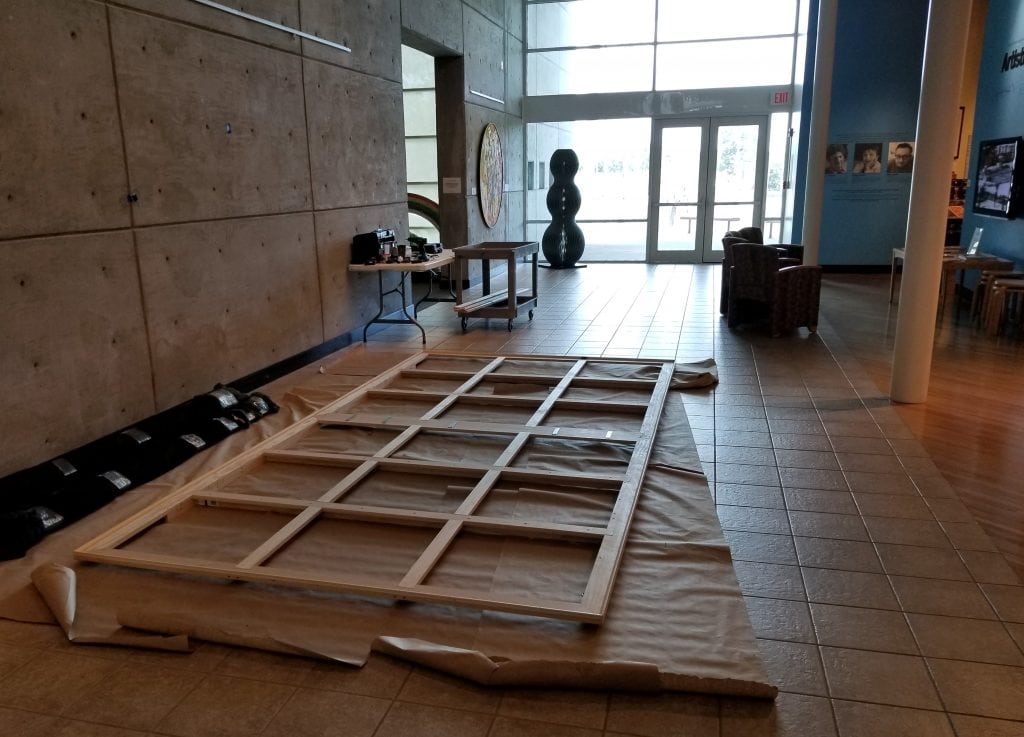 Kevin Grass's stretecher bars for his "Not #MeToo" painting are put back together