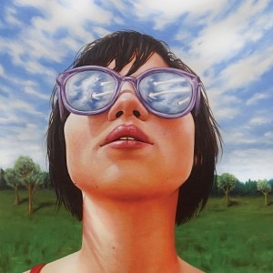 "As I Look To the Sky" is an oil painting depicting an image of a girl looking at the view with a reflection of meteors in her sunglasses standing in an open field 