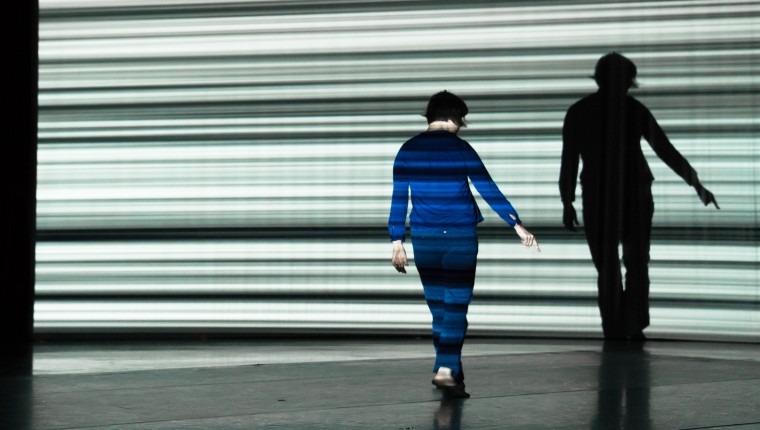 Solo dancer in front of video projection