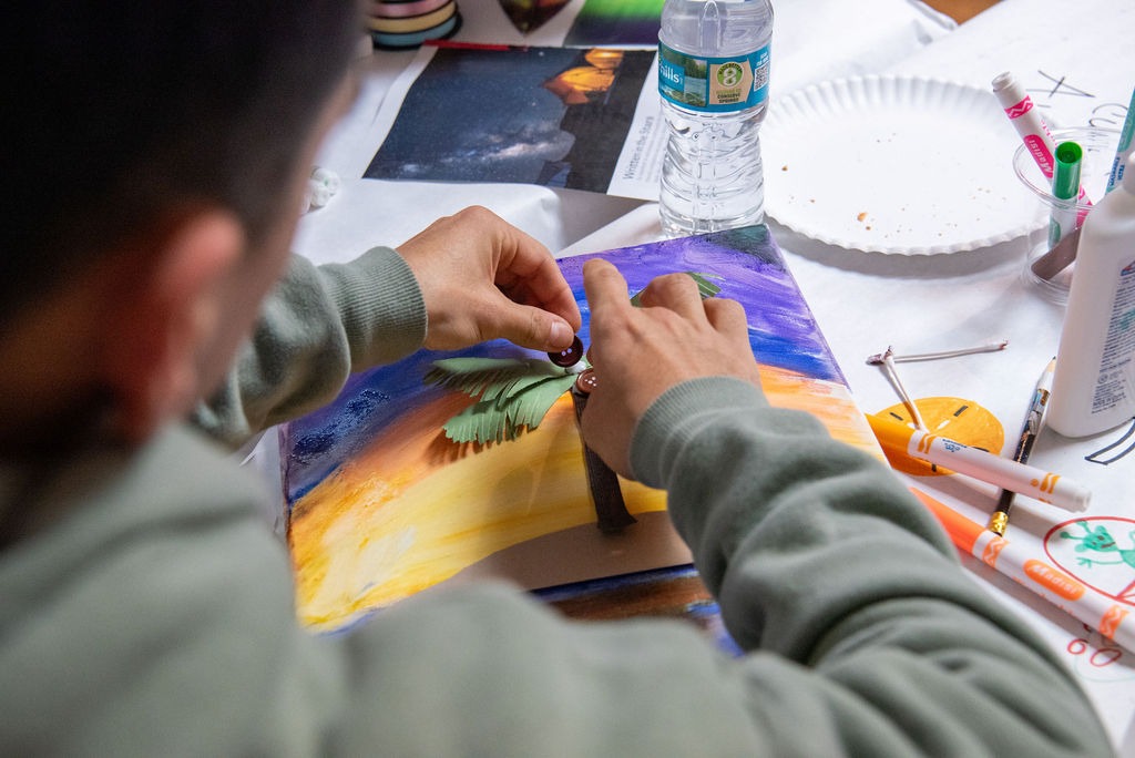 A child works on a piece of art.