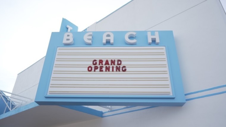 A theater's marquis reads Grand Opening.