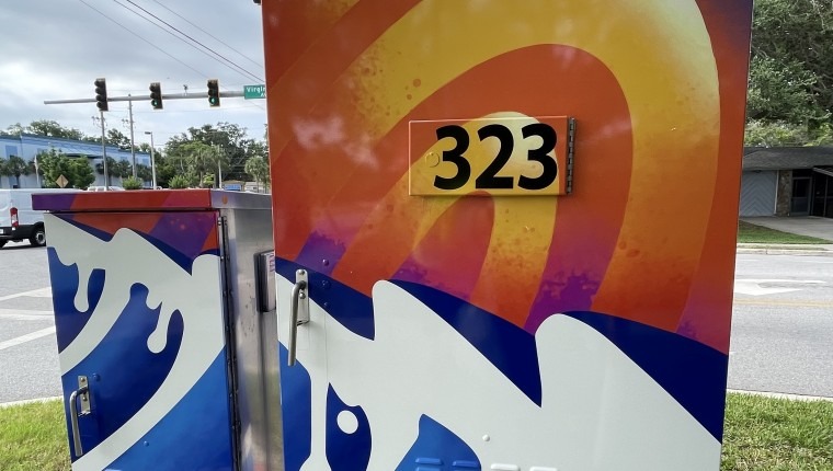 A signal box is decorated with a colorful pattern.