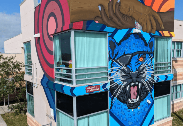 A mural of a jaguar on a school.