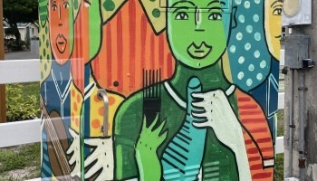 A signal box is decorated with images of figures.