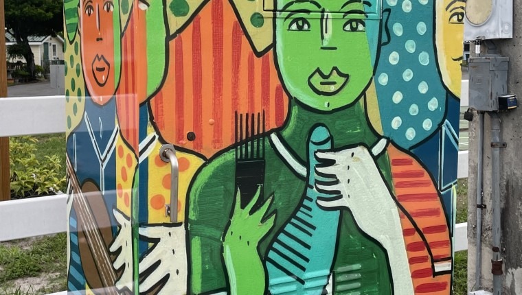 A signal box is decorated with images of figures.