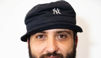 A man wears a bucket hat,