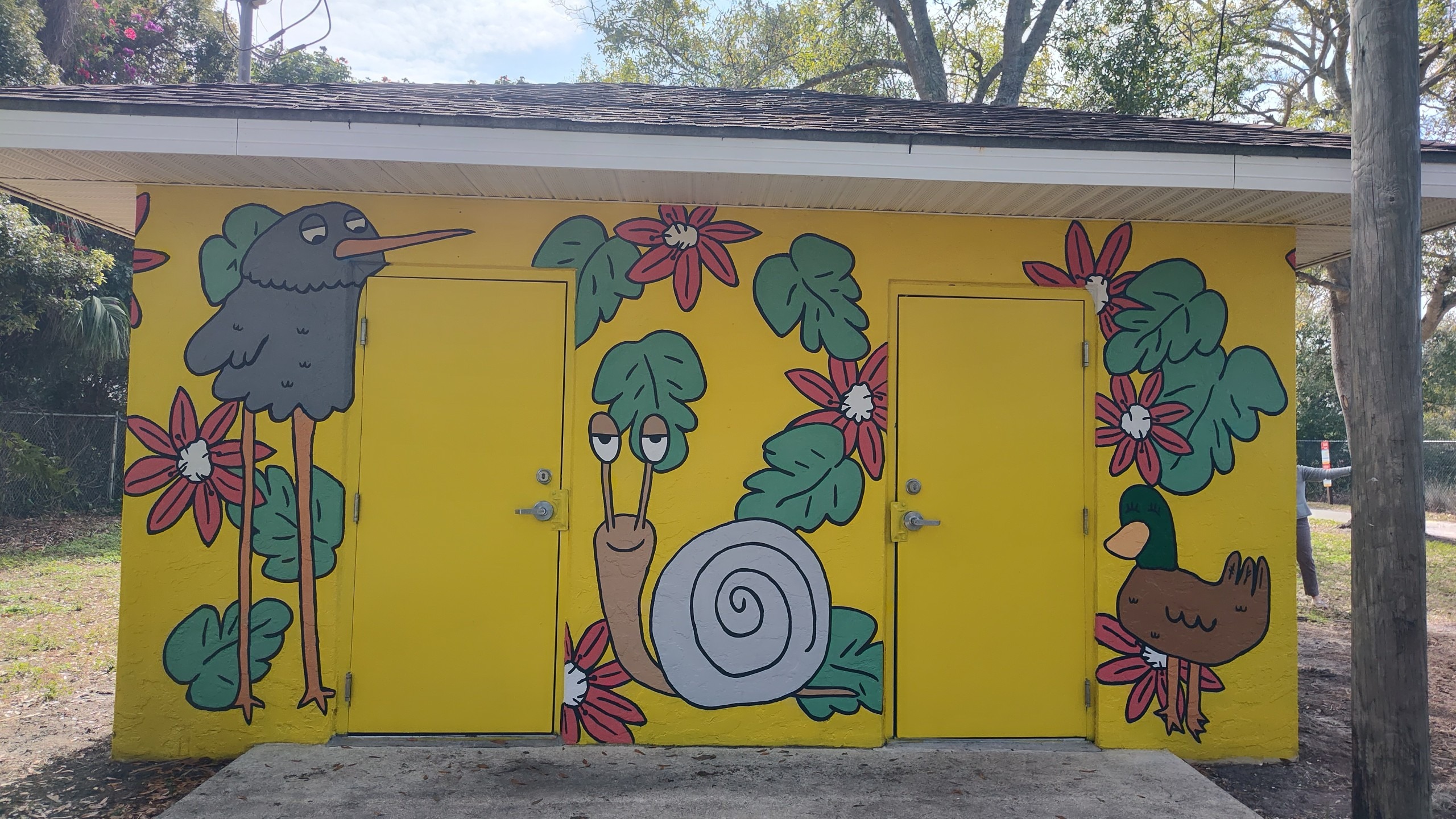 A mural depicts birds and a snail.